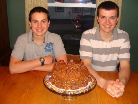 Stephen's 17th and Matthew's 15th birthday cake. It is a Snickers cake. It is a homemade caramel cake with homemade chocolate butter cream frosting with caramel sauce drizzled all over it with mini snickers and nuts as well.